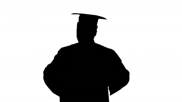 Silhouette Excited african american male student in graduation robe dancing with his diploma moving towards camera. — Stock Video
