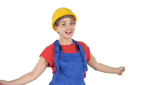 Female construction worker dancing happy on white background. Stock Image