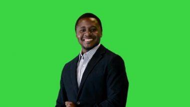 Gülümseyen yakışıklı iş adamı yeşil ekranda dans ederek iyi haberi kutluyor, Chroma Key.