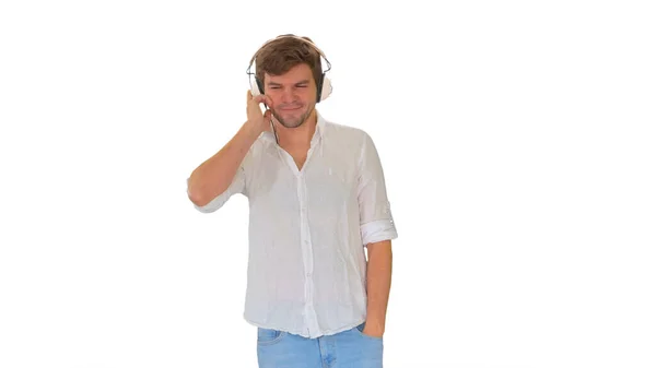 Casual young man listening to music holding headphones by his ha — Stock Photo, Image