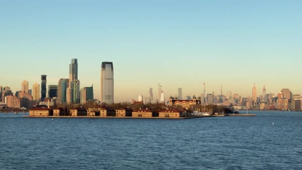 Остров Эллис, Лоуэр Манхэттен и Хобокен с видом на закат из залива Уппер в Нью-Йорке — стоковое видео
