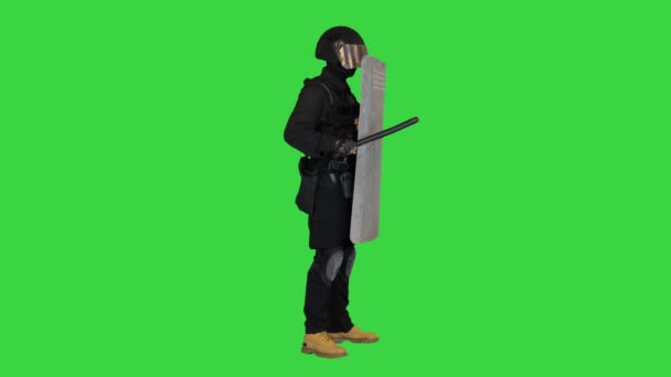 Policía en equipo completo para antidisturbios de pie con un escudo y bastón de goma en una pantalla verde, Chroma Key. — Vídeos de Stock