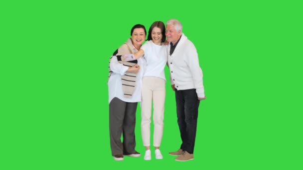 Grand dad, mother and daughter taking a selfie on a Green Screen, Chroma Key. — Stock Video