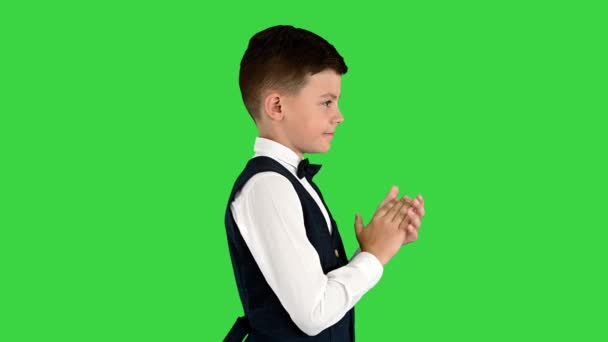 Smiling boy in formal wear clapping on a Green Screen, Chroma Key. — Stock Video