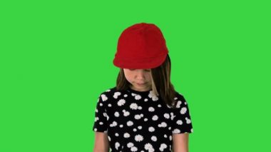 Yeşil ekranda yürüyen ve ayaklarına bakan tatlı Asyalı kız, Chroma Key..