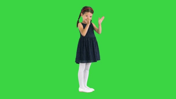 Glad flicka i svart klänning klappar händerna på en grön skärm, Chroma Key. — Stockvideo