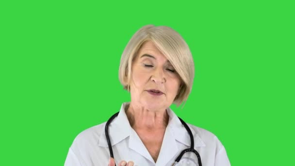 Pleasant carrying doctor lady talking to camera on a Green Screen, Chroma Key. — Stock Video