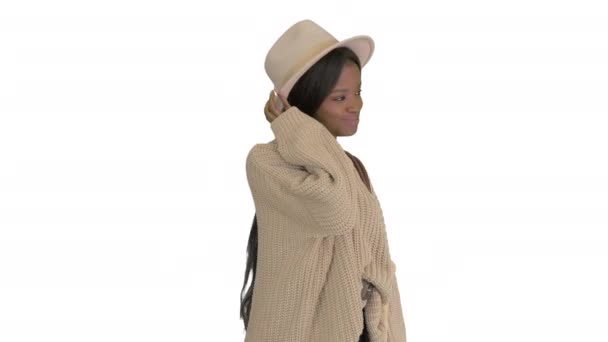 Beyaz arka planda örgü ve beyaz şapka giymiş modaya uygun Afro-Amerikan kadın.. — Stok video