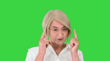 Büyüleyici yaşlı bayan yeşil ekranda biriyle konuşuyor, Chroma Key..
