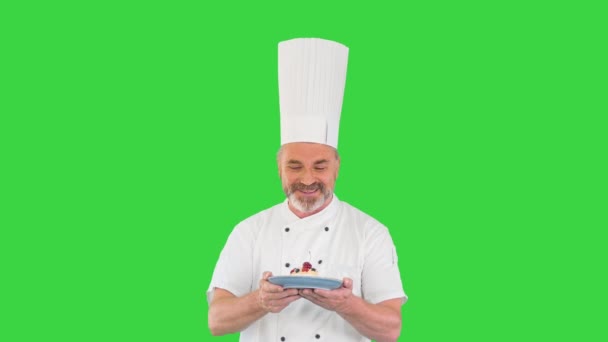 Szczęśliwy dojrzały kucharz spacerujący z pustynią w rękach na zielonym ekranie, Chroma Key. — Wideo stockowe