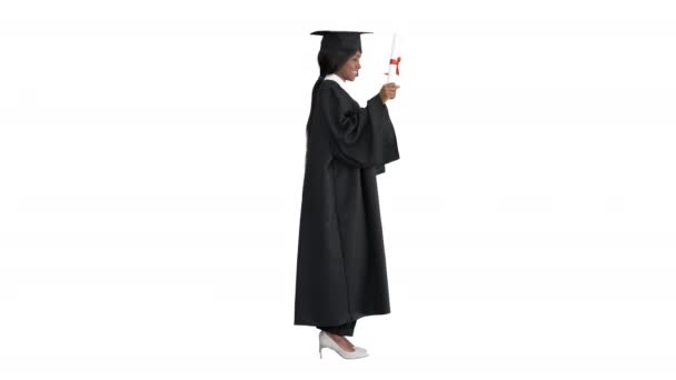Atractiva mujer africana graduada con diploma sobre fondo blanco. — Vídeos de Stock