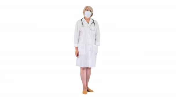 La doctora senior durante una pandemia de coronavirus covid-19 se quita la máscara protectora sobre fondo blanco. — Vídeos de Stock