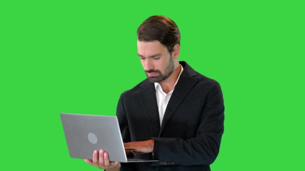Fiatal üzletember dolgozik egy laptop egy zöld képernyőn, Chroma Key. — Stock videók