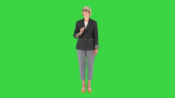 Senior Business Frau zeigt auf die Seiten präsentiert etwas auf einem Green Screen, Chroma Key. — Stockvideo