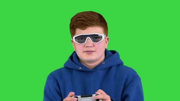 Um menino jogando videogame em uma tela verde, Chroma Key. — Vídeo de Stock