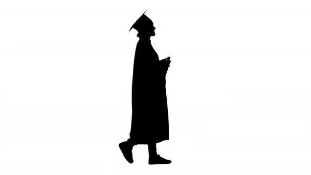 Silhouette Happy female student in graduation robe walking and cheering with her diploma. — Stock Video