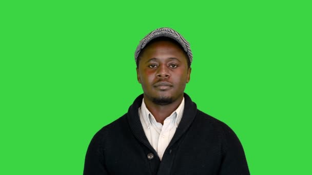 Casual African American man in a hat smiling on a Green Screen, Chroma Key. — Stock Video