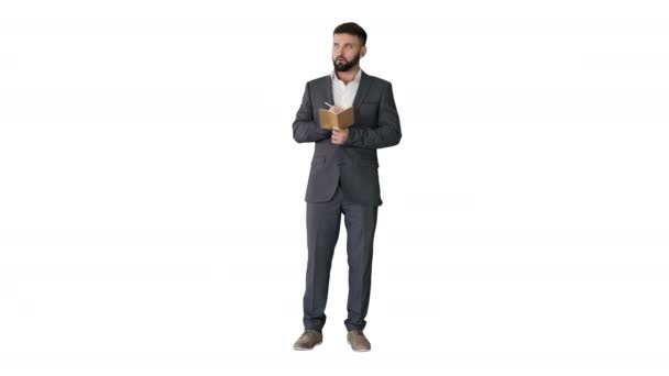 Koncentrált fiatalember formalwear holding jegyzet pad és írás fehér háttér. — Stock videók