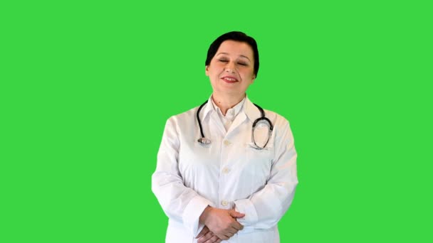 Happy senior female doctor standing on a Green Screen, Chroma Key. — Stock Video