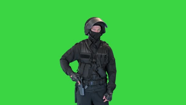 Police tactical officer checking his hand gun and folding hands on a Green Screen, Chroma Key. — Stock Video