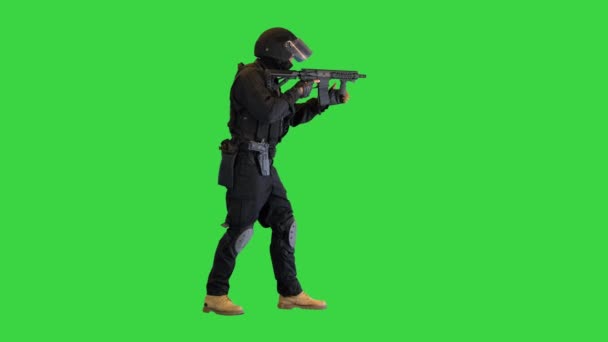 Tactical police unit in black uniform reloading an assault rifle on a Green Screen, Chroma Key. — Stock Video