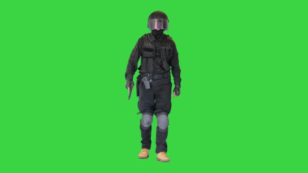 Counter terrorist squad fighter walking with a pistol in a hand on a Green Screen, Chroma Key. — Stock Video