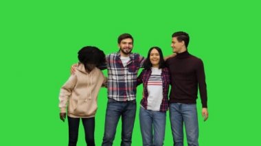 Dört mutlu arkadaş fotoğraf için poz veriyor, hep birlikte sarılıyor ve yeşil ekranda kameraya gülümsüyor, Chroma Key..