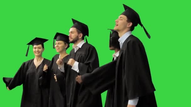 Happy graduation students performing a funny dance on a Green Screen, Chroma Key. — Stock Video