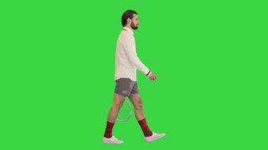 Genç erkek tenisçi yeşil ekranda yürüyor, Chroma Key.