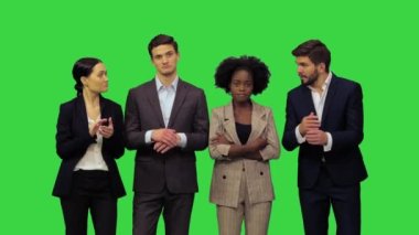 Resmi giysiler içinde genç insanlar alkışlıyor, yeşil ekranda hoparlörle olan anlaşmalarını gösteriyorlar, Chroma Key.