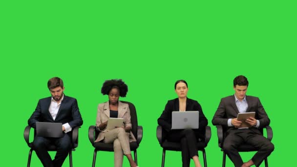 Business people at the presentation taking notes on their laptops, listening attentively, asking questions on a Green Screen, Chroma Key. — Stock Video