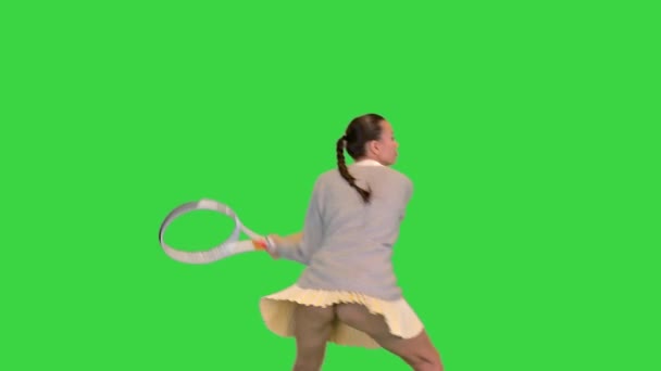 Girl with tennis racket imitating the game on a Green Screen, Chroma Key. — Stock Video