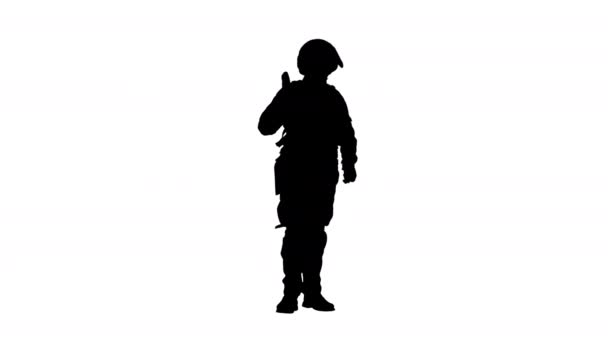 Silhouette Policeman in protective cask with a rifle raised up. — Stock Video