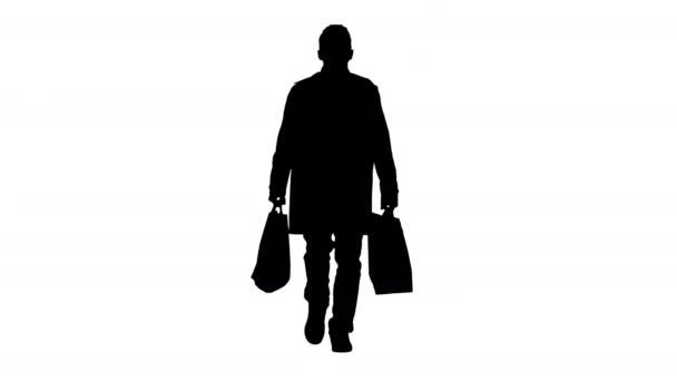 Silhouette Hombre en máscara médica en la cara caminando con bolsas de compras. — Vídeos de Stock