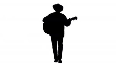 Siluet Yaşlı kovboy yürür, şarkı söyler ve gitar çalar.