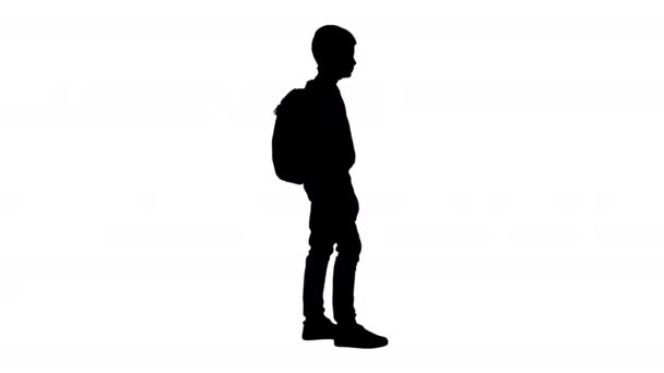 Silhouette Boy en cuello de polo de pie con una mochila. — Vídeos de Stock