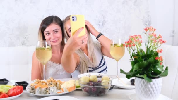 Two happy friends sharing online content using smartphone at home, selective focus — Stock Video