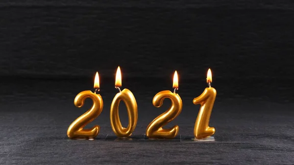 Burning golden New Year candles 2021 on black background. modern concept. — Stock Photo, Image