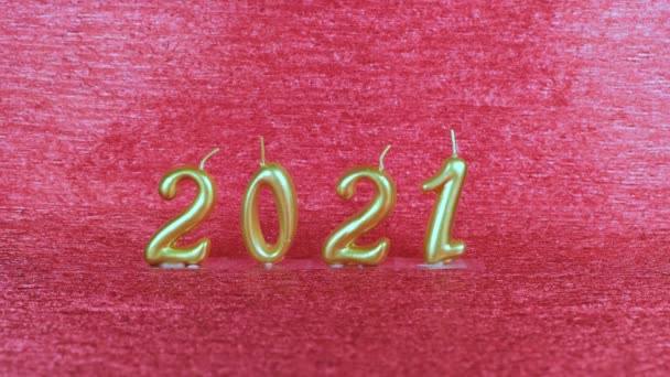Bougies dorées Nouvel An 2021 sur fond rouge. concept moderne. — Video