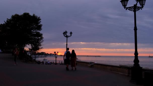 Couple are walking Sevastopol embankment at sunset — Stock Video