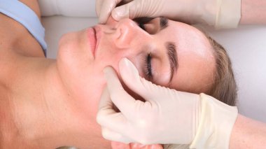 Güzellik salonunda yüz masajı yaptıran güzel bir kadın..