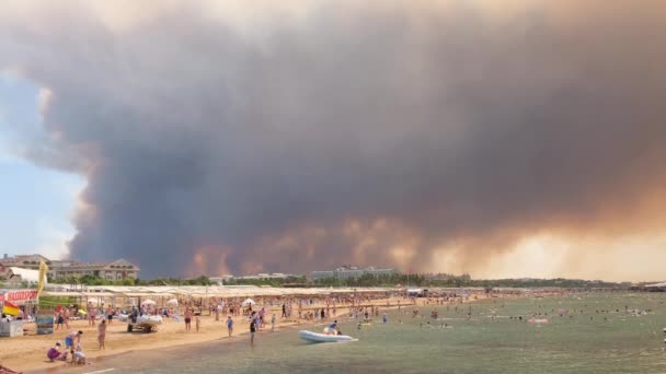 Chamas e fumaça de incêndios florestais cobrem a paisagem. Nuvens de fumaça sobre hotéis e sobre o mar: Antalya, Manavgat Turquia - 28 de julho de 2021. — Vídeo de Stock