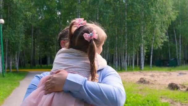 Père heureux portant autour de son cou et embrassant fille 4-5 ans câlins et cercles dans le parc — Video