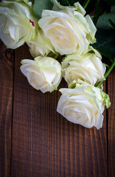 Rosas blancas sobre fondo de madera — Foto de Stock