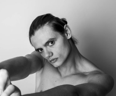 Sexy closeup portrait of handsome topless male model with beautiful eyes. Black and White.