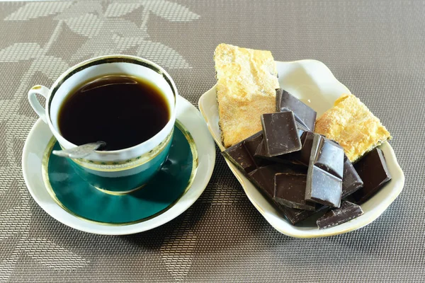 For tea drinking, we prepared a cup of fragrant strong black tea, fresh juicy orange and chocolate.. High quality photo