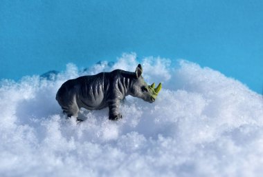 Oyuncak su aygırı beyaz karın üzerinde duruyor..