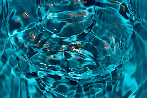 A snapshot of water circles on the surface of the water with blue color and light.