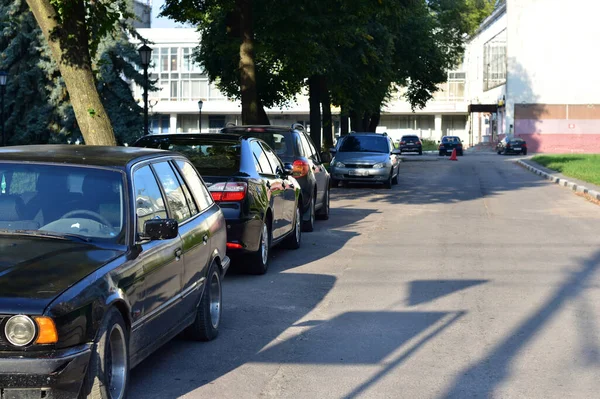 Coches de pie a lo largo de la carretera y la acera. — Foto de Stock