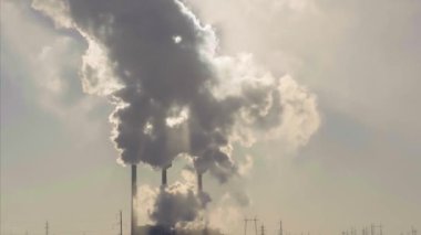 Sigara fabrikası bacaları. Büyük şehirlerdeki çevre kirliliği ve hava kirliliği sorunu. İklim değişikliği, ekoloji ve küresel ısınma. Gökyüzü zehirli maddelerle dumanlı.